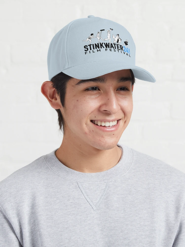 women holds a clapboard in front of her face